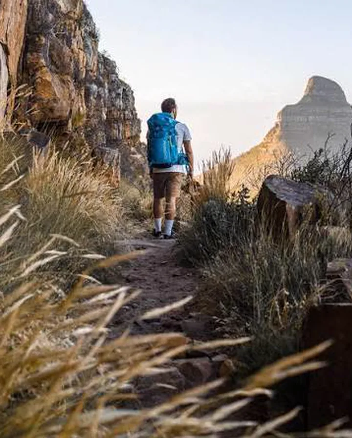 A hiker on a mountain path above Cape Town.